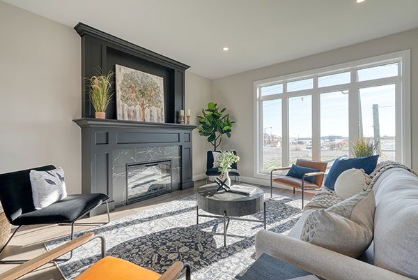 A beautiful living room area with a large fireplace as the focal point.