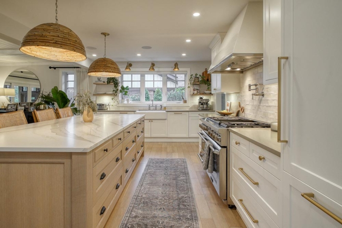 A beautiful kitchen with a generously sized island and a professional oven.