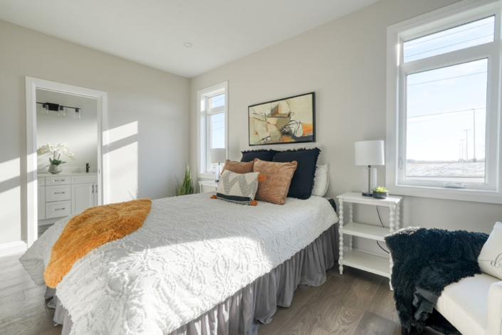 A beautiful guest bedroom with an ensuite in one of Haggerty's new construction homes.