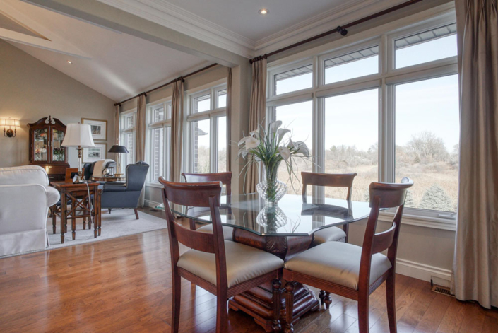 An elegant dining area overlooking green space in one of Haggerty's custom-built homes.
